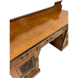 Late 19th century oak raised back sideboard, the rectangular top with moulded and ebonised edge over three frieze drawers and two cupboards carved with floral motifs, raised on a plinth base W180cm, H115cm, D60cm 