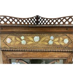 Victorian inlaid walnut floor-standing corner cabinet, the raised back pierced with fretwork with beaded front edge, the frieze inlaid with satinwood and mother of pearl floral designs within an ebony band boxwood striped border, single glazed door enclosing two shelves, raised om cabriole supports