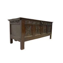 18th century oak coffer or chest, rectangular hinged two plank lid with moulded edge, the frieze carved with lunettes over four carved panels with scrolling and rosette decoration, the panelled sides with carved arch friezes dentilled apron, raised on stile supports 
Provenance: property of a gentleman