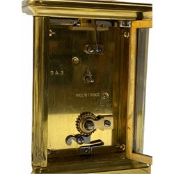 A late 19th century French Corniche cased 8-day timepiece carriage clock with a jewelled lever platform escapement, overcoil balance with timing screws, white enamel dial with Roman numerals and minute markers, steel spade hands, bevelled glass panels to the case and a rectangular glass panel to the top of the case, dial and movement inscribed “Made in France”.    With key.                  