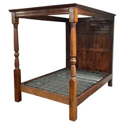 17th century design oak four-poster bedstead, projecting moulded cornice over moulded upper rails, the headboard with two over six panels, turned column front posts, with metal sprung base