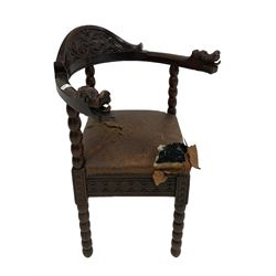 Oak corner chair with blind carved back rail over leather seat, raised on turned bobbin supports 