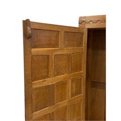 Mouseman - panelled and adzed double wardrobe, arcade carved top rail over two panelled doors, with wrought metal hinges and latch, relief carved mouse signature, the interior fitted with hanging rail, by the workshop of Robert Thompson, Kilburn