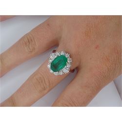 18ct white gold emerald and diamond cluster ring, the central oval emerald with baguette, tapered baguette and round brilliant cut diamonds, stamped 750, emerald 2.46 carat, with World Gemological Institute Report