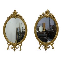 Pair of Victorian giltwood and gesso framed oval wall mirrors, the cartouche pediment with extending foliage, the border carved with egg and dart decoration and outer leafage and berries, the terminal decorated with scrolling acanthus leaves
Provenance: From the Estate of the late Dowager Lady St Oswald