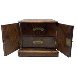 Victorian figured wanut table top cabinet fitted with two interior drawers, countersunk brass handles and enclosed by a pair of panelled doors on a plinth base W34cm x H29cm x D28cm 
