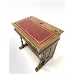 Old Charm - 20th century oak writing desk, the sloped top with inset tooled red leather writing surface lifting to reveal storage well, over lunette and floral carved frieze, two turned pilasters and two panelled doors, raised on sledge supports W94cm, D59cm, H91cm