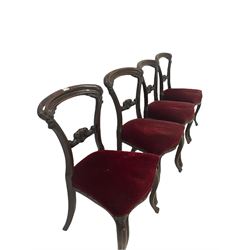 Set four Victorian dining chairs with scroll carved cresting rail and back rail, over seats upholstered in red fabric, raised on cabriole legs 