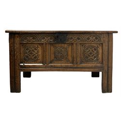 Early 19th century carved oak blanket box, the hinged three panelled lifting lid over carved base, raised on stile supports 
