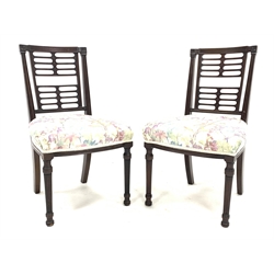 Pair late 19th mahogany side chairs, the fluted and flower head carved cresting rail over a horizontally pierced back, moulded uprights, seats upholstered in floral cover, turned and reeded supports, seat width - 48cm, seat height - 44cm