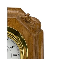Mouseman - oak and brass wall clock, circular Roman dial in brass drum on moulded octagonal mount carved with mouse signature, fitted with battery operated Quartz movement, by the workshop of Robert Thompson, Kilburn 