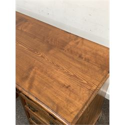 Late Victorian pitch pine twin pedestal desk, the rectangular top with moulded edge over one long and two banks of five graduated drawers, with skirted base W121cm, H78cm, D56cm