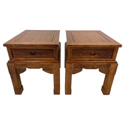 Pair Chinese Imperial style hardwood lamp or side tables, panelled rectangular form, carved with foliate motifs and trailing geometric patterns, each fitted with single drawer, on square supports