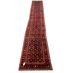 Persian Hamadan red ground runner, decorated with an all over floral design 477cm x 82cm