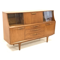 1970s teak sideboard, central fall front flanked by two sets of sliding glass doors, three drawers and two cupboards below, W167cm, H104cm, D44cm
