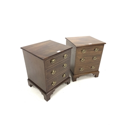 Pair of mahogany bedsides, with hinged tops revealing plain interiors, over three faux drawers, raised on shaped bracket supports, W39m