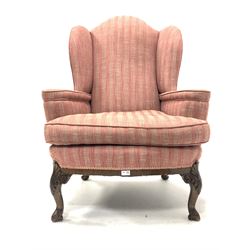 Early 20th century Chippendale style mahogany framed wing back armchair, upholstered in stripped and herringbone pink fabric, with squab cushion, raised on shell and acanthus carved cabriole front supports W87cm, Hight to seat 51cm