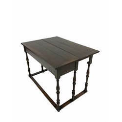 Early 20th century oak console table, the rectangular fold over top with double gate leg action, raised on turned supports with floor stretcher, terminating in castors 