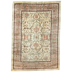 Persian Heriz pale camel ground rug, the central coral pole medallion enclosing palmettes, the field decorated with extending foliate patterns, the border guarded by crimson bands and filled with repeating stylised plant motifs