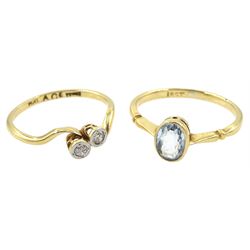 Early 20th century two stone diamond crossover ring and a gold single stone oval aquamarine ring, both stamped 18ct