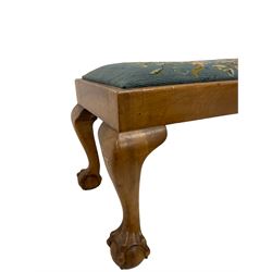 Early 20th century walnut footstool, the upholstered drop in pad, raised on cabriole supports with ball and claw feet 