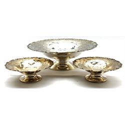 Silver fruit bowl with overlaid lappet decoration within a partly pierced border on a short pedestal foot D23cm together with a pair of matching smaller dishes D13cm Sheffield 1960/61 Maker Mappin & Webb 17.8oz