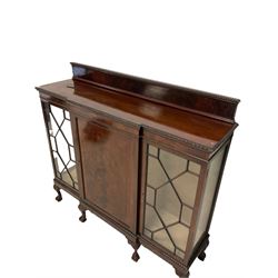 Edwardian mahogany breakfront display cabinet, the raised back over one cupboard enclosing two fixed shelves, flanked by two glazed doors of astragal design, raised on ball and claw feet 