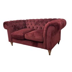 Two seat Chesterfield sofa, upholstered in buttoned red velvet with loose seat cushions, retailed by John Lewis