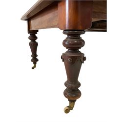 Victorian mahogany dining table, rectangular moulded top with telescopic extending mechanism, two additional leaves and winder, turned supports with carved decoration on brass and ceramic castors