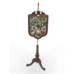  Victorian walnut pole screen broken arch pediment over a bead and needle work tapestry panel of shield form, turned baluster shaped lobe carved column raised on leaf carved triple splay supports, H149cm  