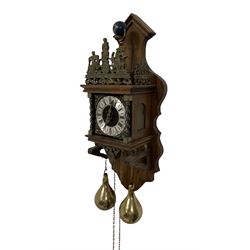 20th century Dutch style Zaanse Zaandam wall clock with a German eight-day weight driven movement housed in a wooden case on a shelf bracket, with a brass effect chapter ring and cherub spandrels, striking the hours and half hours on a bell. With weights and pendulum.
 H 50 W 20 D13 
