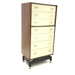 G-Plan tall chest, fitted with seven drawers with brass handles, raised on ebonised base and brass supports, W61cm, H128cm, D43cm