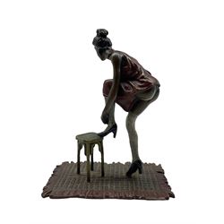 A cold painted bronze of a lady with her foot on a stool, in the manner of Bergman, stamped beneath, H13.5cm