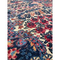 Persian hand knotted blue, ivory and red ground rug, with all over floral design 263cm x 380cm