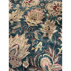 Indo-Persian emerald ground thick pile carpet, the field decorated with large lotus and Boteh motifs connected by scrolling foliate tendrils, the guarded citrine border with stylised plant and lotus motifs