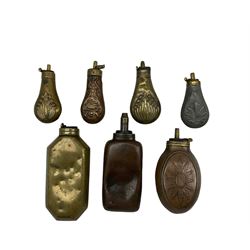 Collection of powder flasks, in brass and copper, three having embossed shell decoration and one of oval design L17.5cm max (7)