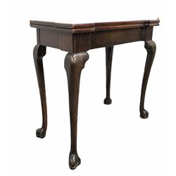 George II mahogany fold over tea table, the shaped top with candlestick corners folding on single gate leg, raised on cabriole supports W80cm