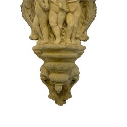 Classical design cast stone corbel, the relief body decorated with mischievous Putti flanked by eagles, the terminal decorated with an urn in the form of a Gorgoneion Medusa mask