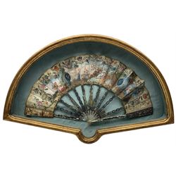 18th century fan, possibly Italian, the mother-of-pearl sticks and guard carved, pierced, silvered and gilded, the silk leaf painted with figures at various pursuits in gardens after Fragonard, within a border of brightly painted flowers, silvered sequins and gilt foliage, framed and glazed, L60cm x H37cm. Provenance: From the Estate of the late Dowager Lady St Oswald