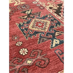Persian design Heriz red ground rug, with repeating medallion on red field, enclosed by guarded border,  230cm x 158cm