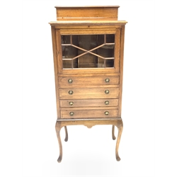 Edwardian mahogany music cabinet with inlaid satinwood banding, raised back over astragal glazed door enclosing interior with three divisions, four fall front drawers under,  raised on cabriole supports