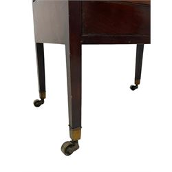 George III mahogany four-division Canterbury, the concave shaped dividers over a single drawer with pressed brass rosette plate and ring handle, raised on square supports terminating in brass cups and castors