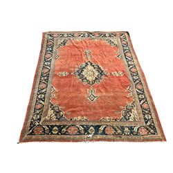 Sultanbed rug, one navy and ivory medallion within red field, enclosed by navy border 404cm by 325cm