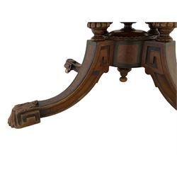 Victorian inlaid walnut loo table, oval quarter match figured veneer top with moulded edge, inlaid with satinwood and ebony scrolls and foliate decoration, the banded frieze with ebony stringing, the turned, fluted and gadroon cluster column support united by a quadriform base with splayed supports with ebony inlay terminating in geometric and foliate moulded feet with ceramic castors