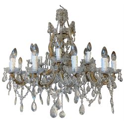 Large eighteen-light glass and gilt metal chandelier, central baluster glass column above six scrolled arms, each terminating three sconces with glass drip pans, suspended throughout with prism drops, faceted beaded chains and central faceted ball pendant, H86cm (including ball pendant) x W88cm approx