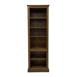 Ercol - open elm bookcase with four adjustable and one fixed shelves, raised on a plinth base 