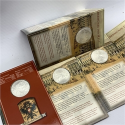 Five Maria Theresa restrike Thaler silver coins, each presented in a card display