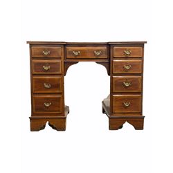 Edwardian mahogany breakfront knee hole desk, the top with inset skiver writing surface over one long and two banks of short graduated drawers with satinwood inlay, raised on shaped plinth supports with recessed castors W99cm, D61cm H76cm