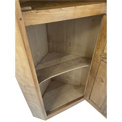 'Gnomeman' adzed oak corner cupboard, fitted with one lead glazed door enclosing two loose shelves over one panelled door with carved Yorkshire rose enclosing one loose shelf, carved with gnome signature, by Thomas Whittaker of Little Beck