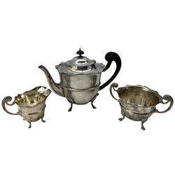 A late Victorian matched silver three piece tea set, comprising teapot with ebonised handle, milk jug and twin handled sugar bowl, with cyma edge and raised on pad feet, teapot hallmarked William Adams Ltd, Birmingham 1900, milk jug and sugar bowl William Adams Ltd, Chester 1900 (3)